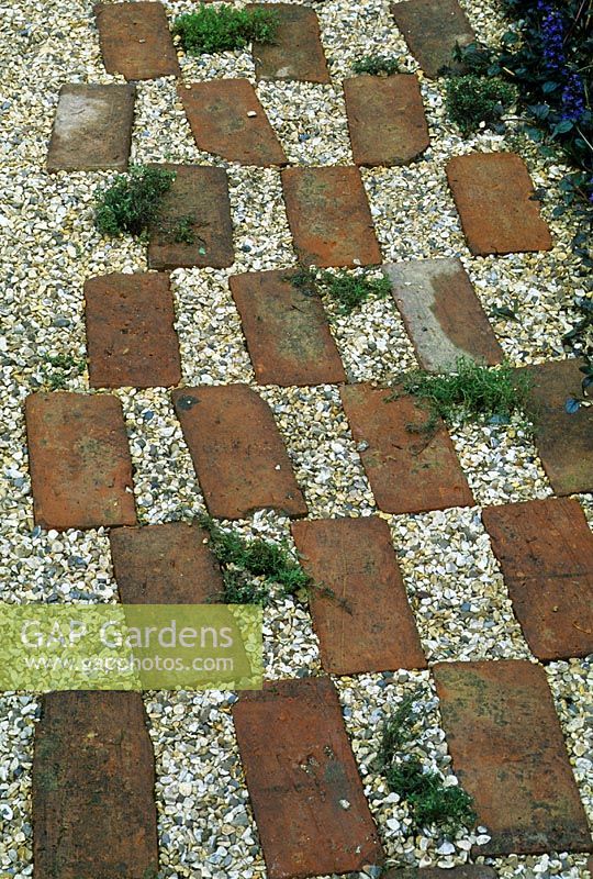 A brick and gravel path in the 'A Brush with the Past' garden at the RHS Chelsea Flower Show