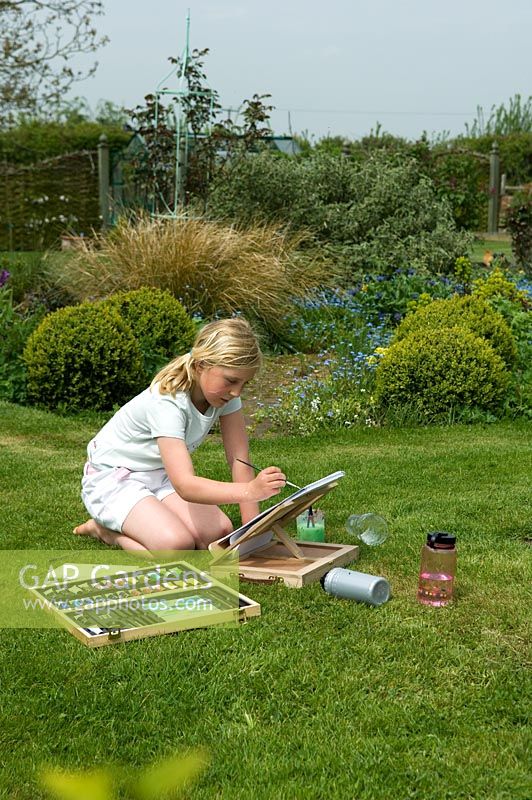 Girl painting in garden