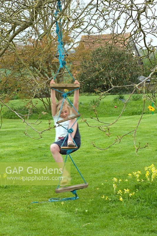 Girl playing on ropeladder in spring garden
- Pannells Ash Farm, West Pentlow, Essex