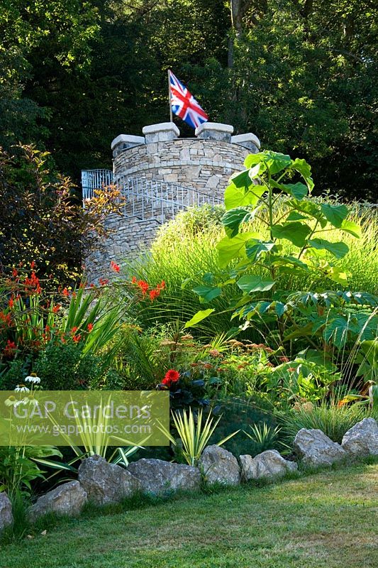 Tropical border with the new round tower - Yewbarrow House Gardens, Cumbria