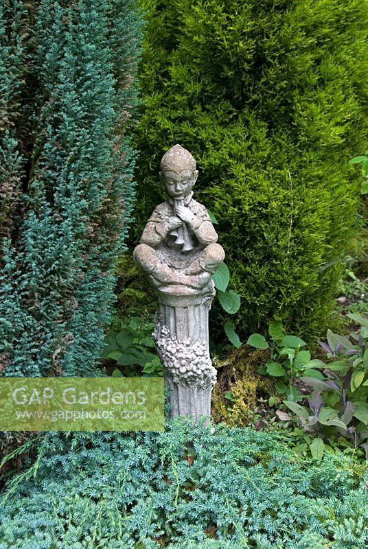 Statue of Pan surrounded by conifers at Cascades Gardens, Derbyshire NGS 