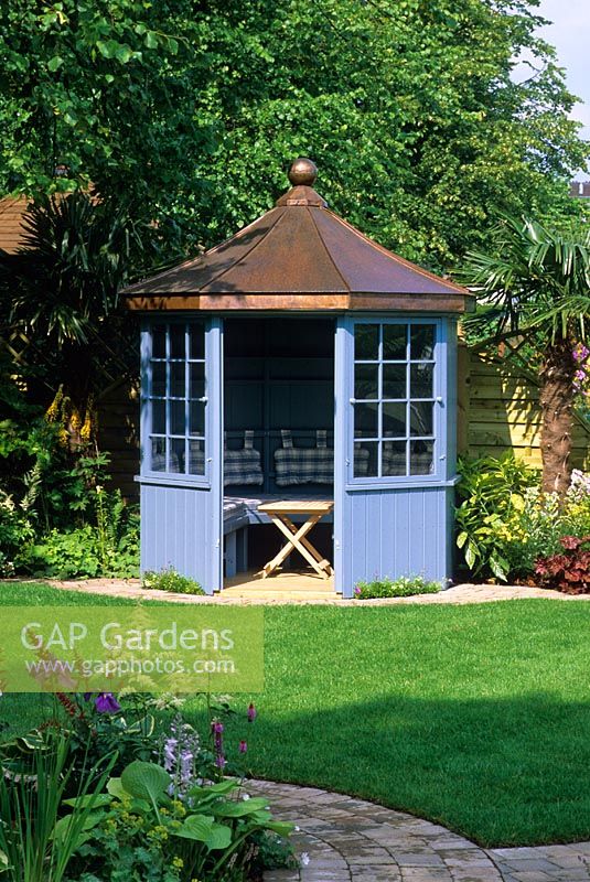 Blue painted summerhouse in the 'Family Retreat' garden at the RHS Hampton Court Flower Show