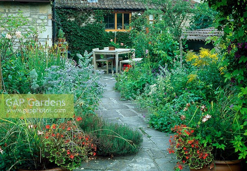 Slate pathway leads through garden to seating area - Saltford Farm, Bath, UK
