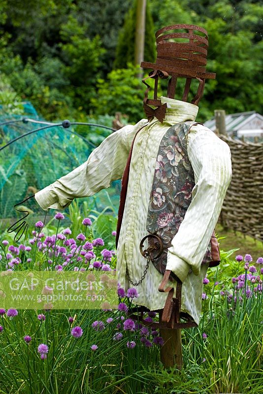 Scarecrow at edge of vegetable garden - Mill Dene Gardens, Blockley, Gloucestershire
