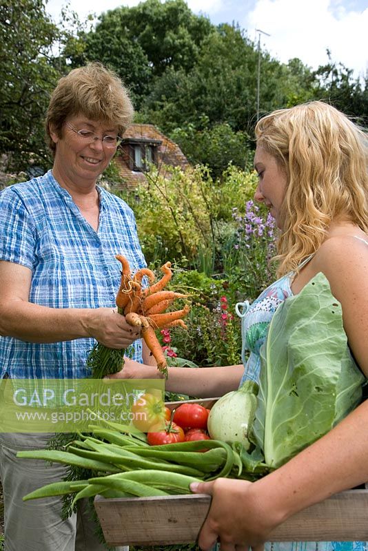 Woman giving vegetables away