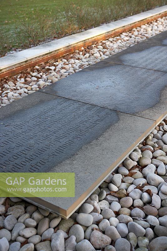 Inscription on stone slabs on bed of pebbles at The Sir Harold Hillier Gardens.