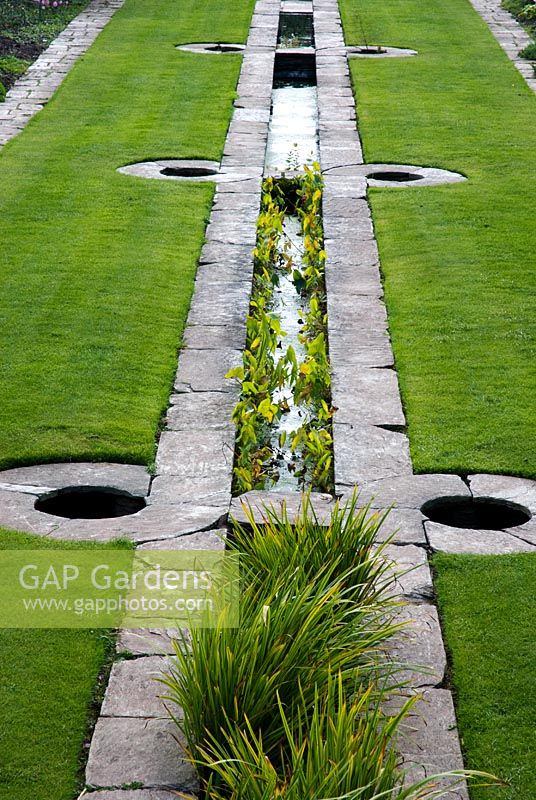 Water rill in middle of lawn with marginal plants - Hestercombe Gardens, Somerset