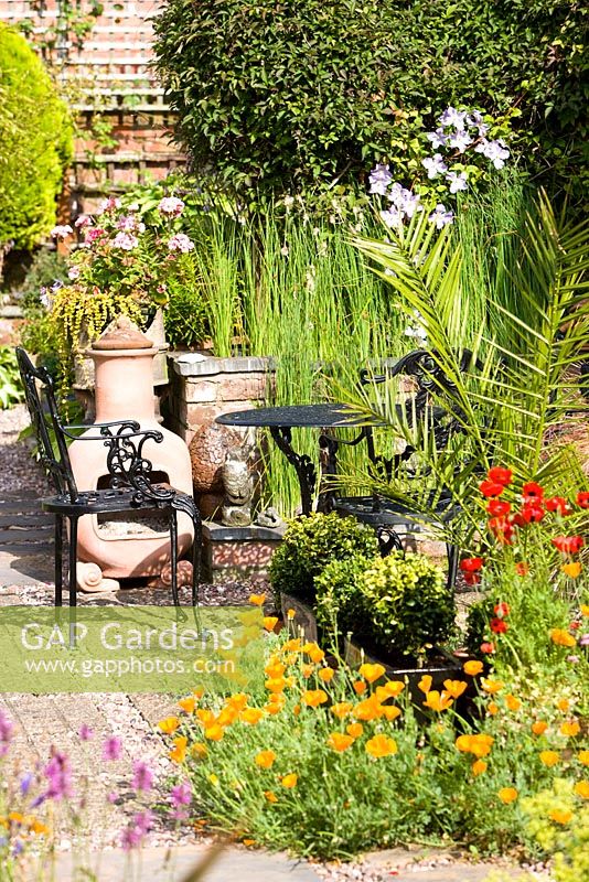 Black wrought iron table and chairs on a garden patio