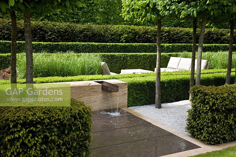 Water feature, clipped hedges and Calamagrostis x acutiflora 'Karl Foerster' - The Laurent-Perrier Garden, Sponsored by Champagne Laurent-Perrier - Gold medal winner at RHS Chelsea Flower Show 2009