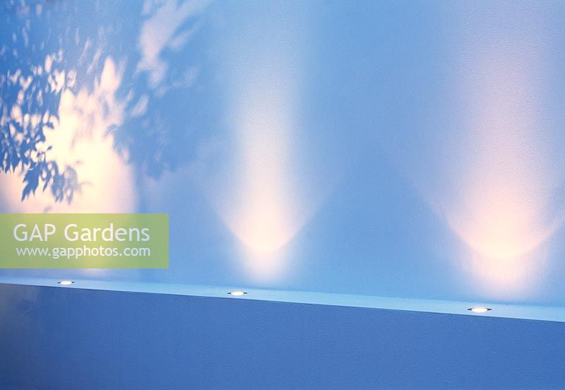 Night lighting introduces drama to this minimalist design, small garden