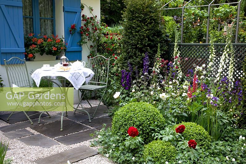Mixed border and table set for tea - Entente Cordiale, A Touch of France Garden, sponsored by Bonne Maman, Clarke and Spears Clarke and Spears International Ltd, The English Garden Magazine - Silver-Gilt Flora medal winner for Courtyard Garden at RHS Chelsea Flower Show 2009
