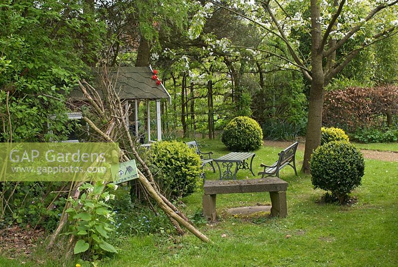 Children's garden with 'Eeyore's den' and wendyhouse - Poulton Hall, NGS garden, Cheshire