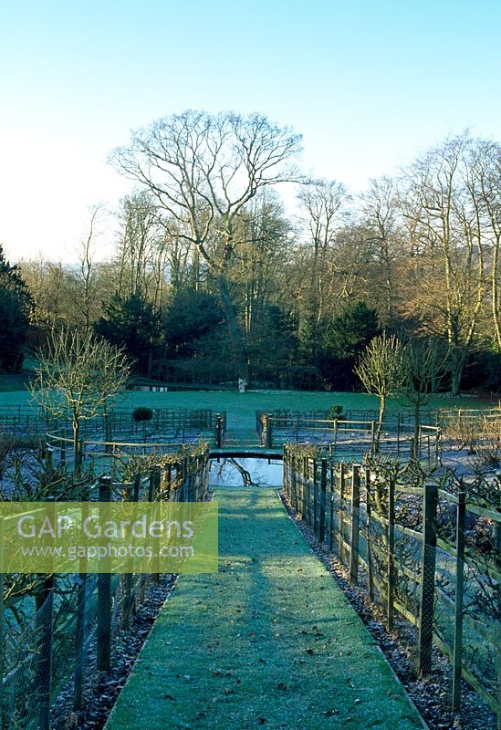 View to the Kitchen Garden Pond and Bowling Green from within the Kitchen Garden - Painswick Rococo Garden, Painswick, Gloucestershire in February