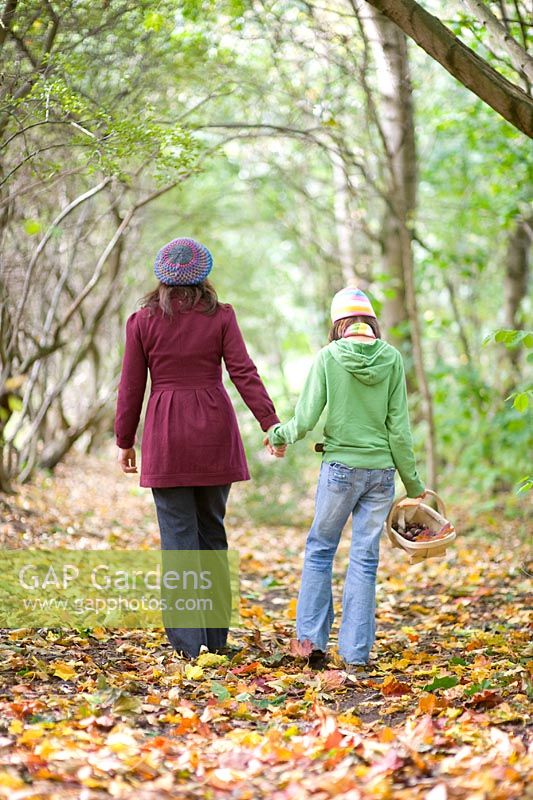 Young girl and woman in Autumn woodland