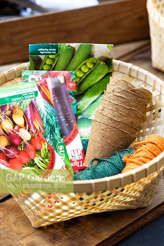 Basket filled with seedpackets, strings and biodegradable fibre pots