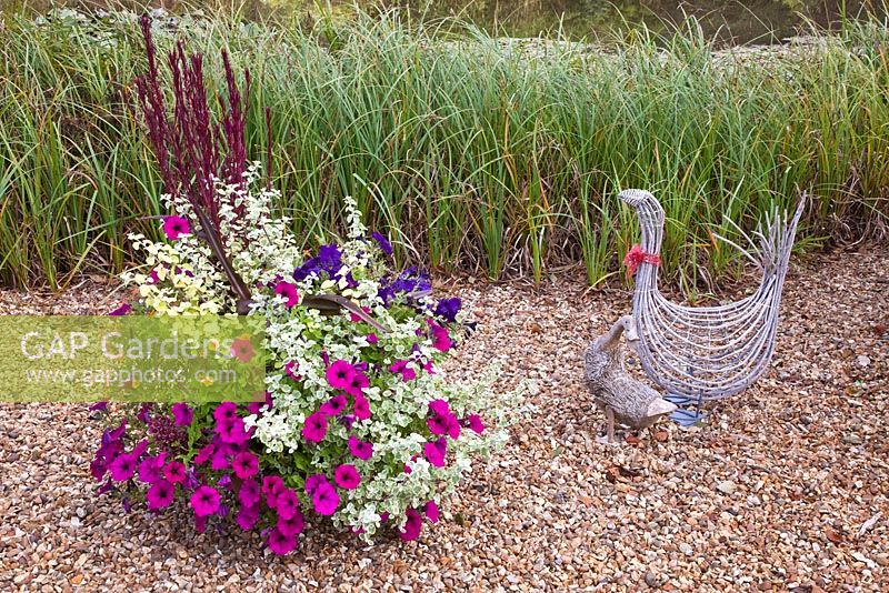 Ornaments Willow Goose and duck with pot packed with annuals at Wilkins Pleck (NGS) in late summer at Whitmore near Newcastle-under-Lyme in North Staffordshire
