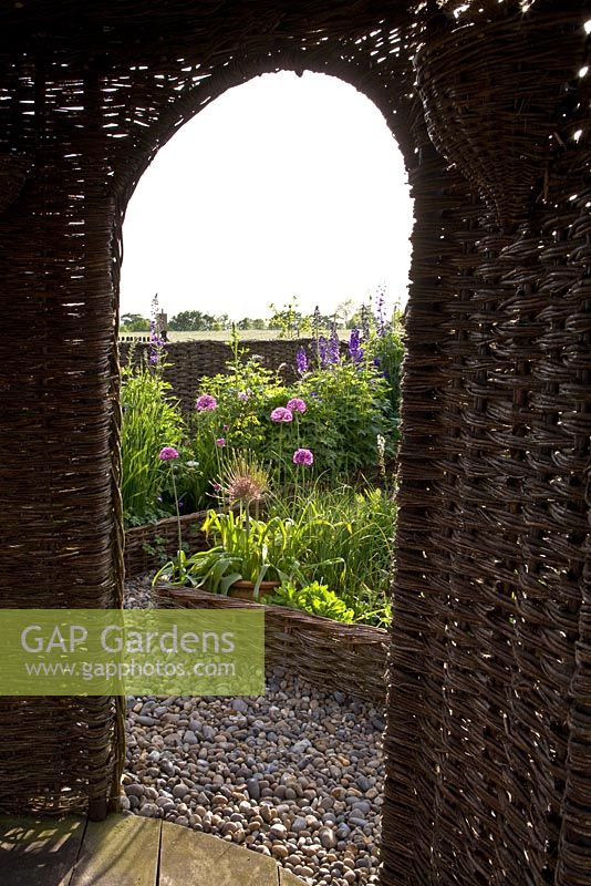 Woven archway of pavilion, with view to garden - brampton Willows