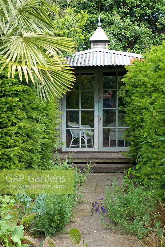 Colonial looking summerhouse framed by Taxus baccata and Trachycarpus fortunei - Montford Cottage, Lancashire