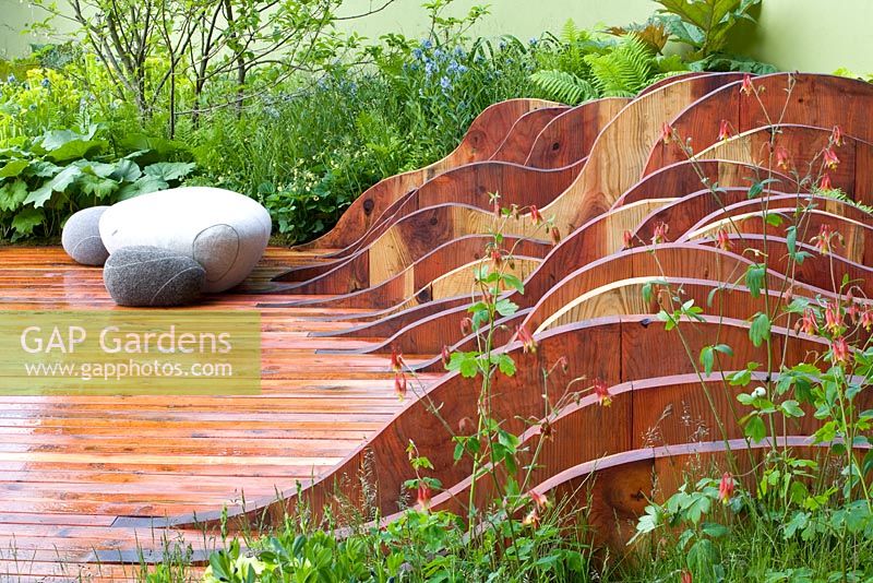 Decking with sculptures - The Foreign and Colonial Investments Garden, Sponsored by Foreign and Colonial Investment Trust, Contractor The Outdoor Room - Silver Flora medal winner at RHS Chelsea Flower Show 2009 