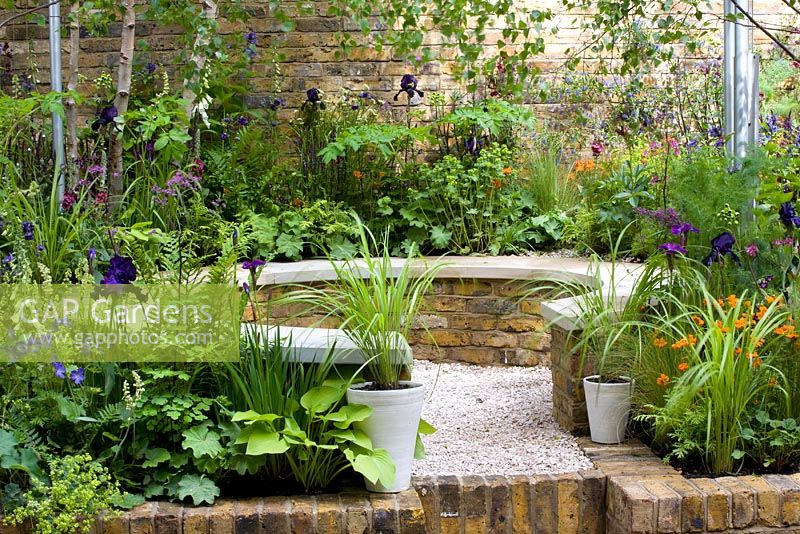 Small garden with raised brick flowerbeds