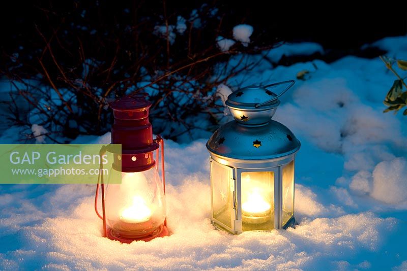 Tea light lanterns in snow
