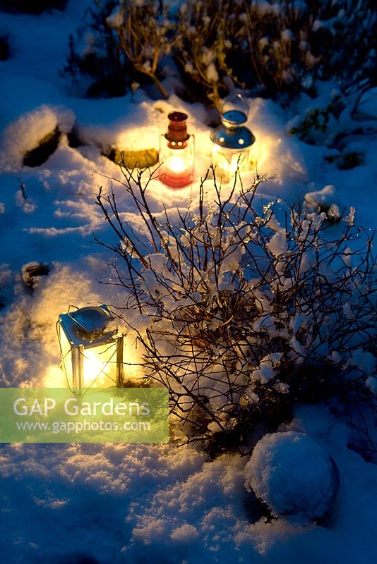 Tea light lanterns in snow
