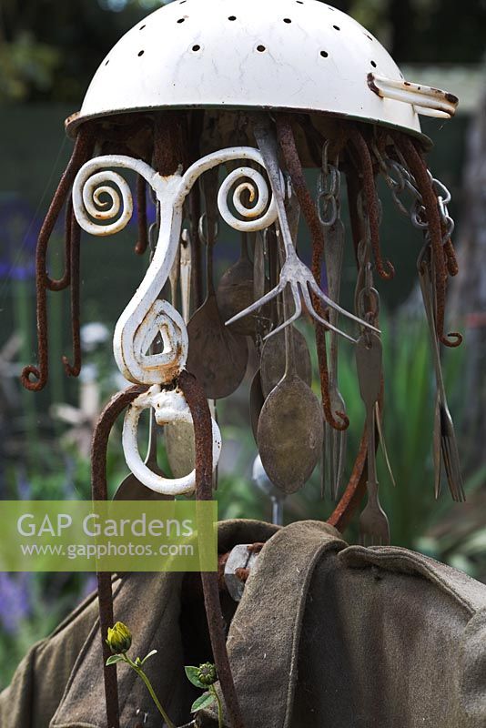 Seaside Inspired garden. Scarecrow made from old pitchfork, colander, old cutlery with army jacket.