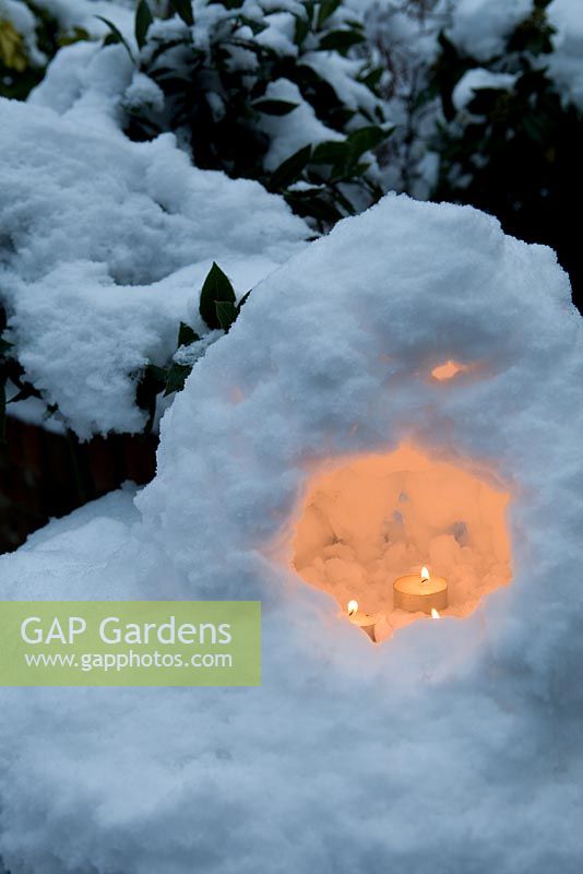 Tea light candles set in miniature snow grotto