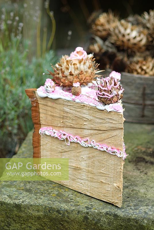 Faux Cake slice. Log section decorated with acanthus seedheads
