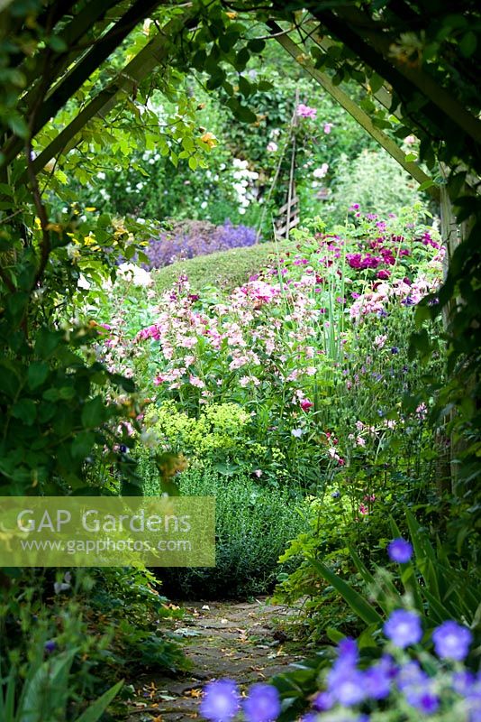 View of the Secret Garden through the rose tunnel