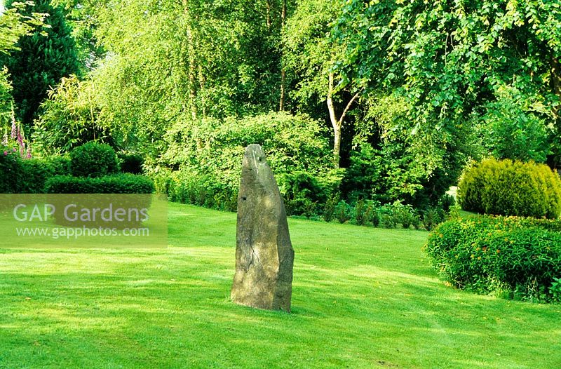 Stone focal point in The Lower Garden,  Cae Hir Garden, Cribyn, Ceredigion. June. Garden open to the public.