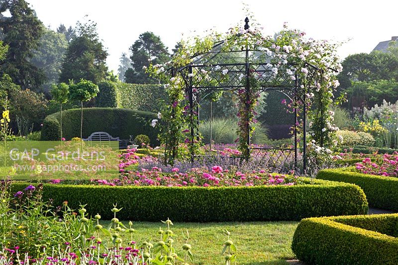 Formal garden with gazebo, planting includes - Nepeta 'Six Hills', Rosa 'New Dawn', Clematis 'Rouge Cardinal' and Clematis 'Etoile Violette' with low clipped box edging 