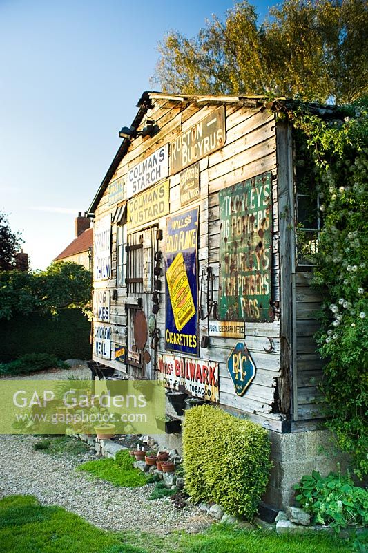 Old barn decorated with vintage enamel advertising signs
