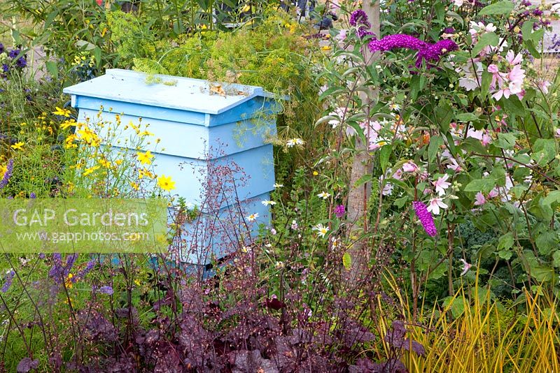 Beehive in flowerbed