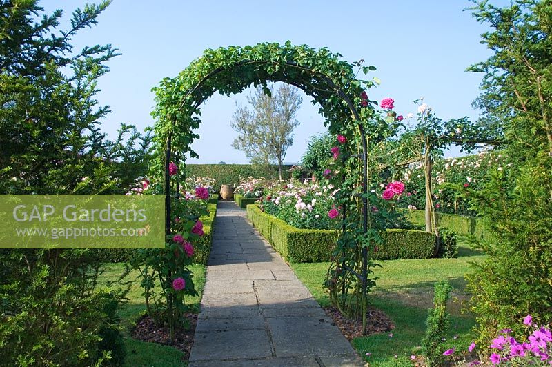 The archway leading to the english rose garden. Town Place Garden, Sussex