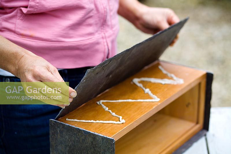 Making a slate planter. Gluing slate to the sides of a wooden box