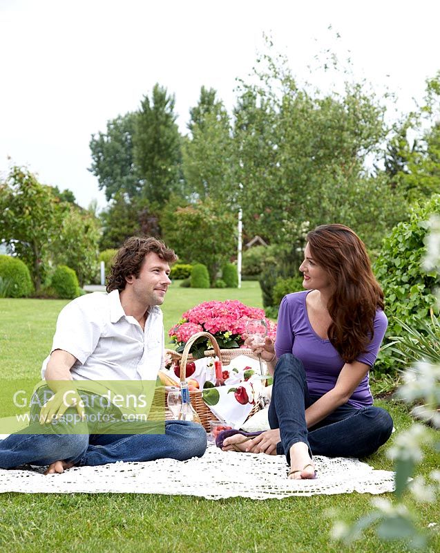 Couple enjoying a picnic in a garden