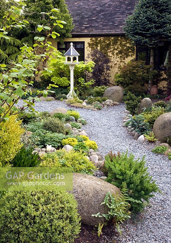 Gravel path leading to Dovecote with borders of rockery either side.  John Massey's Garden, Ashwood, West Midlands 