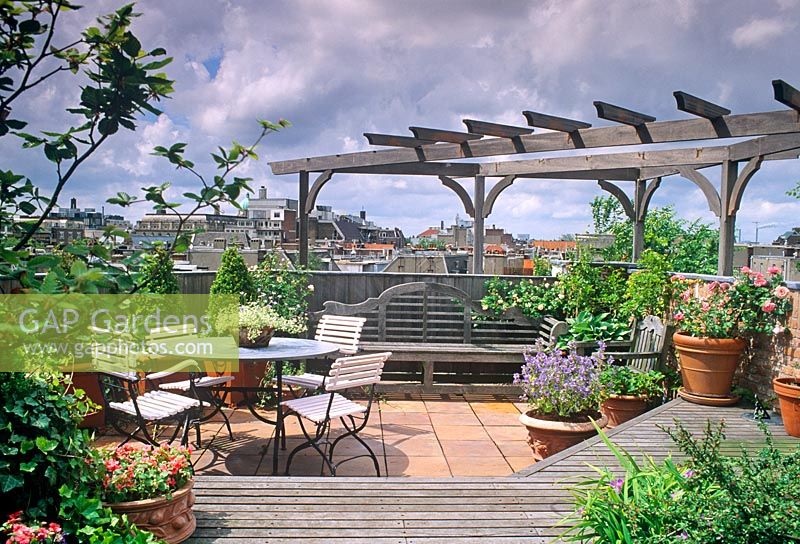 Roof garden with wooden pergola, terracotta containers and furniture - Amsterdam, Holland 