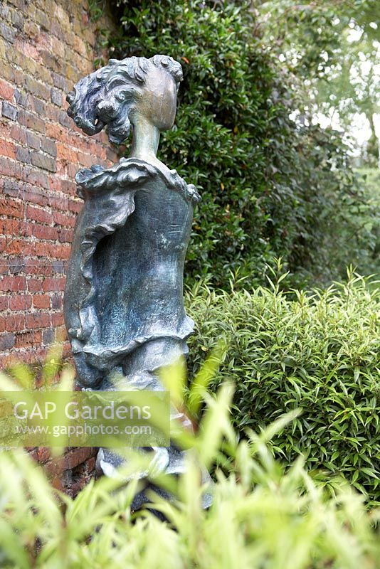 'Siren' statue by Derek Howarth, amidst Sarcococca - Hatfield House, Hertfordshire