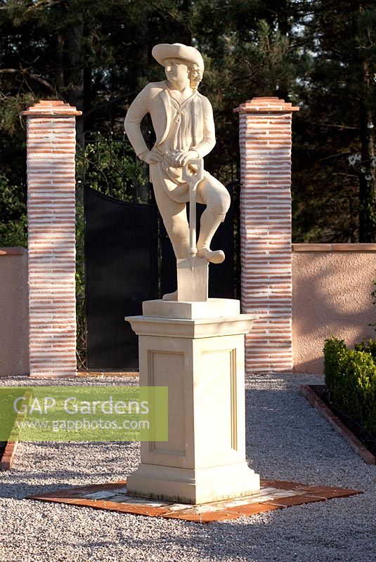 Replica 18th century garden statue of man leaning on spade 