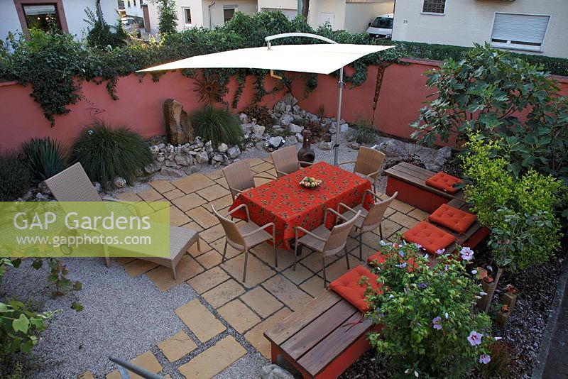 Urban patio garden with sunshade and furniture