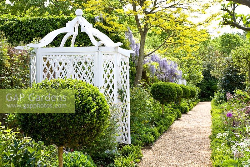 Pavilion in country garden with clipped box standards