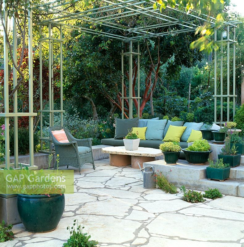 Outdoor seating under trellised patio. Southern California, USA