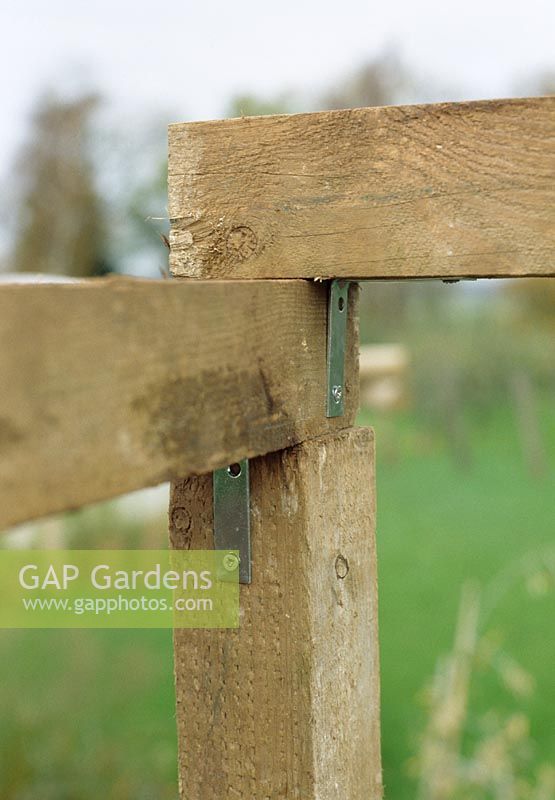 Making a pergola - Fix verticals to horizontals on the ground first, then verticals to cross pieces, then the meta posts can be tightened up. Attach cross pieces using U shaped brackets, secured with galvanised nails