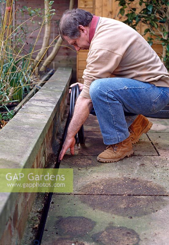 Watering supply kit - If you are building a patio, a good tip is to leave a gully between a wall and the paving to keep pipes hidden from view, while giving easy access to the water supply