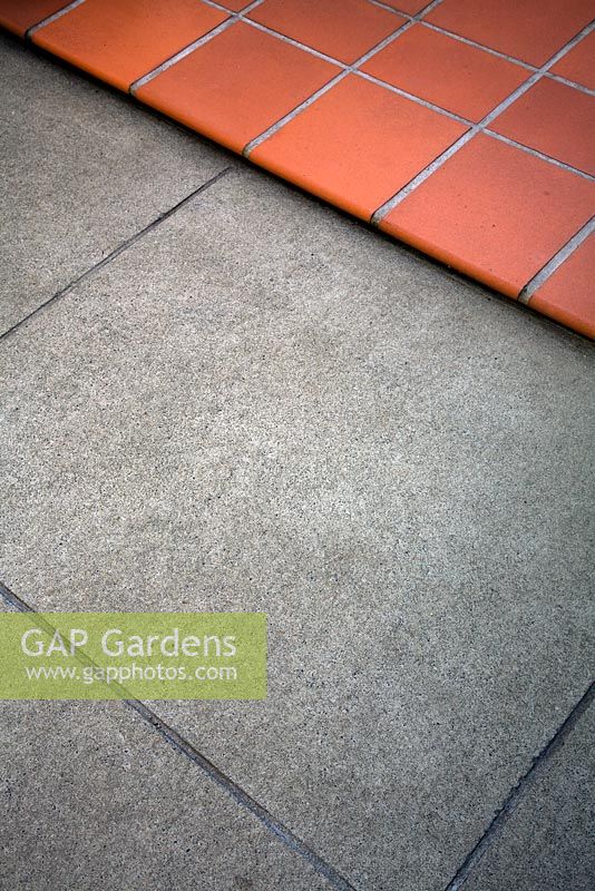 Detail of contrasting paving of scored concrete slabs and terracotta tiles. Christchurch, New Zealand