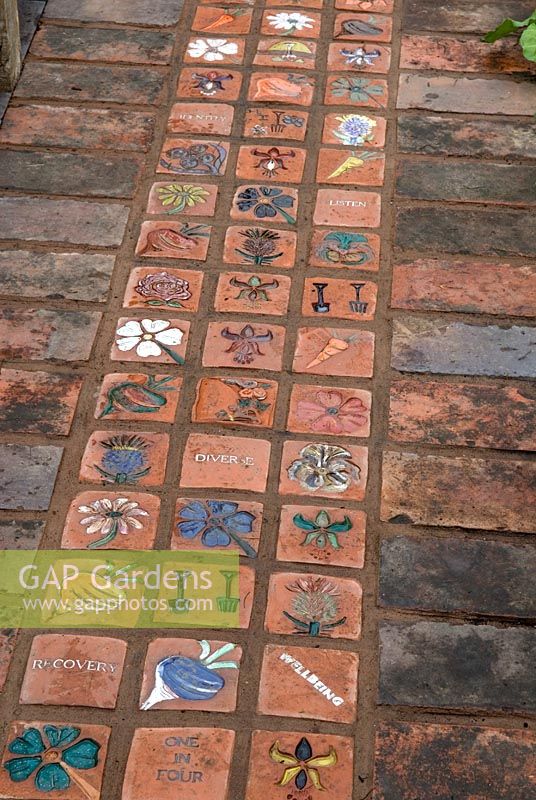 Brick garden path with hand made terracotta tiles depicting garden themes in 'The Recovery and Wellbeing Garden', Gold Award Winner - Malvern Spring Show 2010