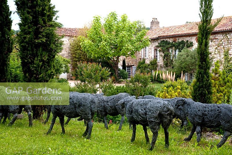 Flock of wire sheep by Sophie Ryder and Tarnaise garden, France.