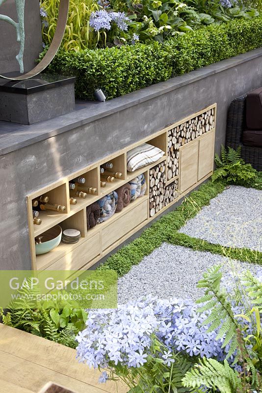 Sunken patio area with storage built into wall of raised bed. 'A Joy Forever' Garden, Silver medal winner at RHS Chelsea Flower Show 2010 
 